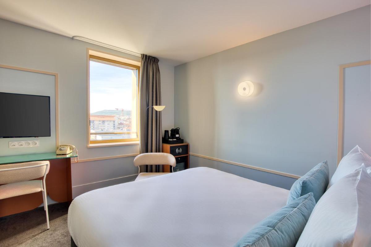 Un ou plusieurs lits dans un hébergement de l'établissement Aiden by Best Western Clermont-Ferrand Hotel & Spa