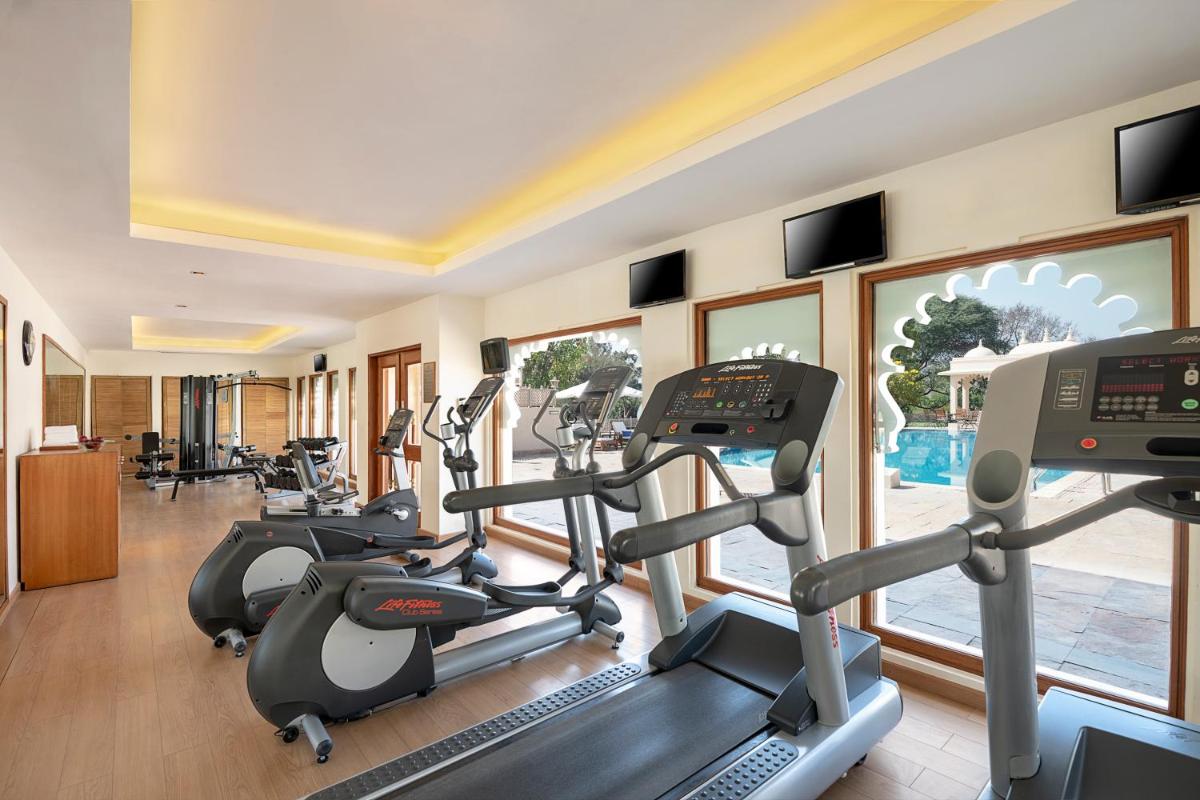 a fitness room with treadmills and elliptical machines at Trident Udaipur in Udaipur