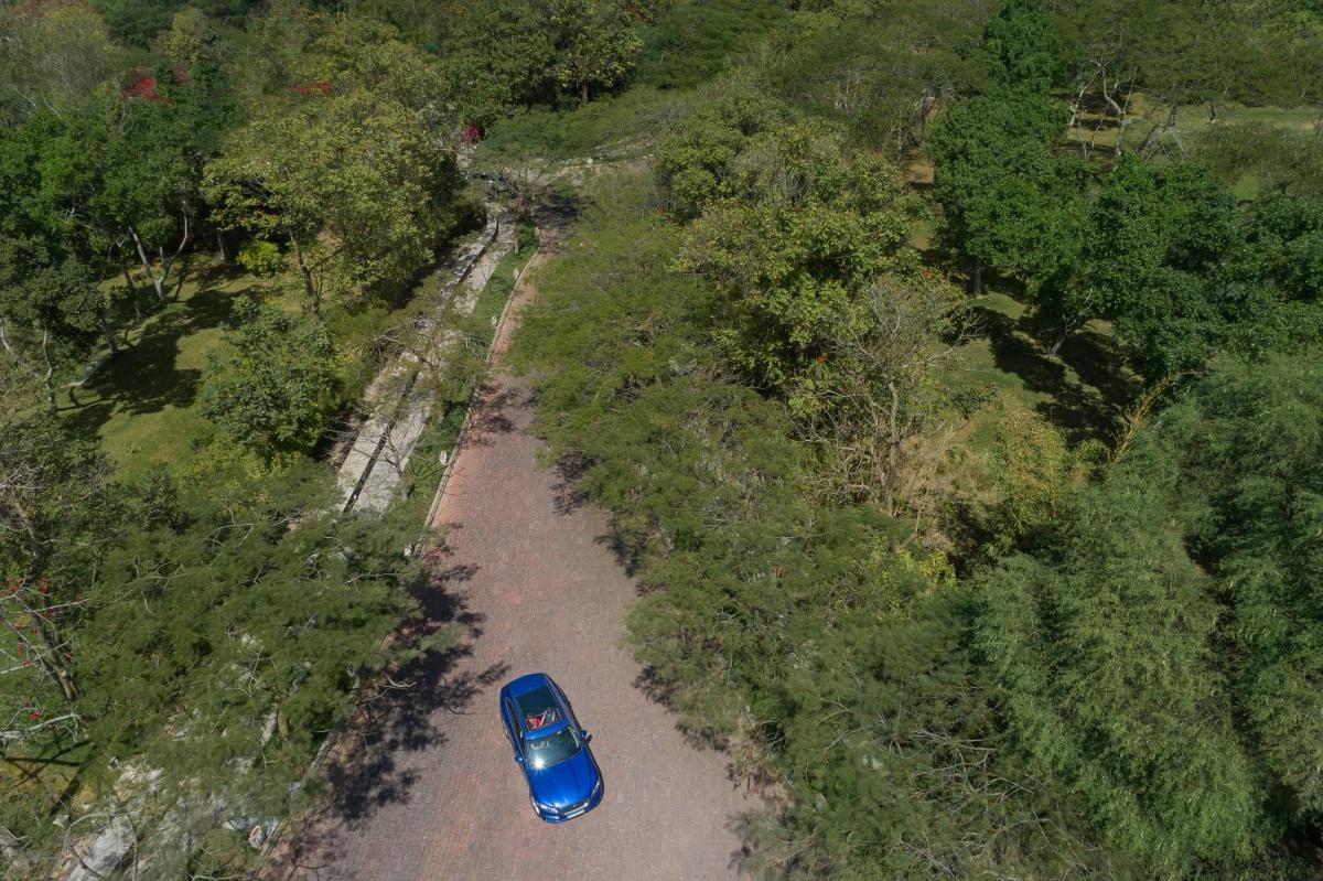 an overhead view of a blue car driving down a road at Trident Udaipur in Udaipur