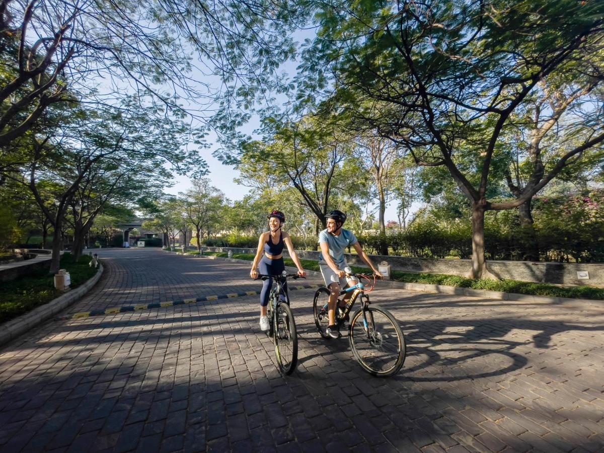a boy and a girl riding bikes down a street at Trident Udaipur in Udaipur