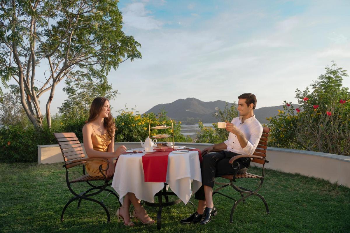 a man and a woman sitting at a table at Trident Udaipur in Udaipur