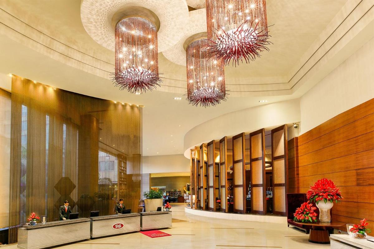 a lobby with two chandeliers in a building at Crowne Plaza Today Gurugram by IHG in Gurgaon