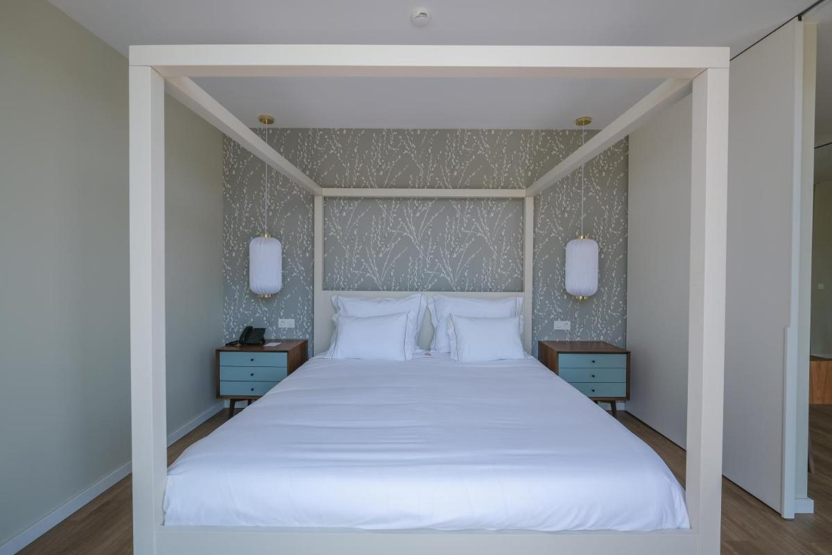 Uma cama ou camas num quarto em Hotel Vouga