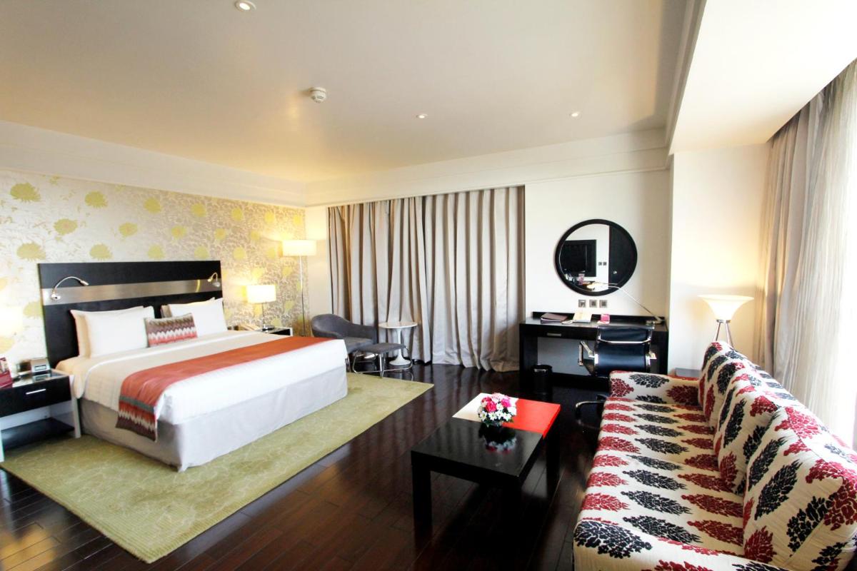 a hotel room with a bed and a couch at Crowne Plaza Pune City Centre by IHG in Pune