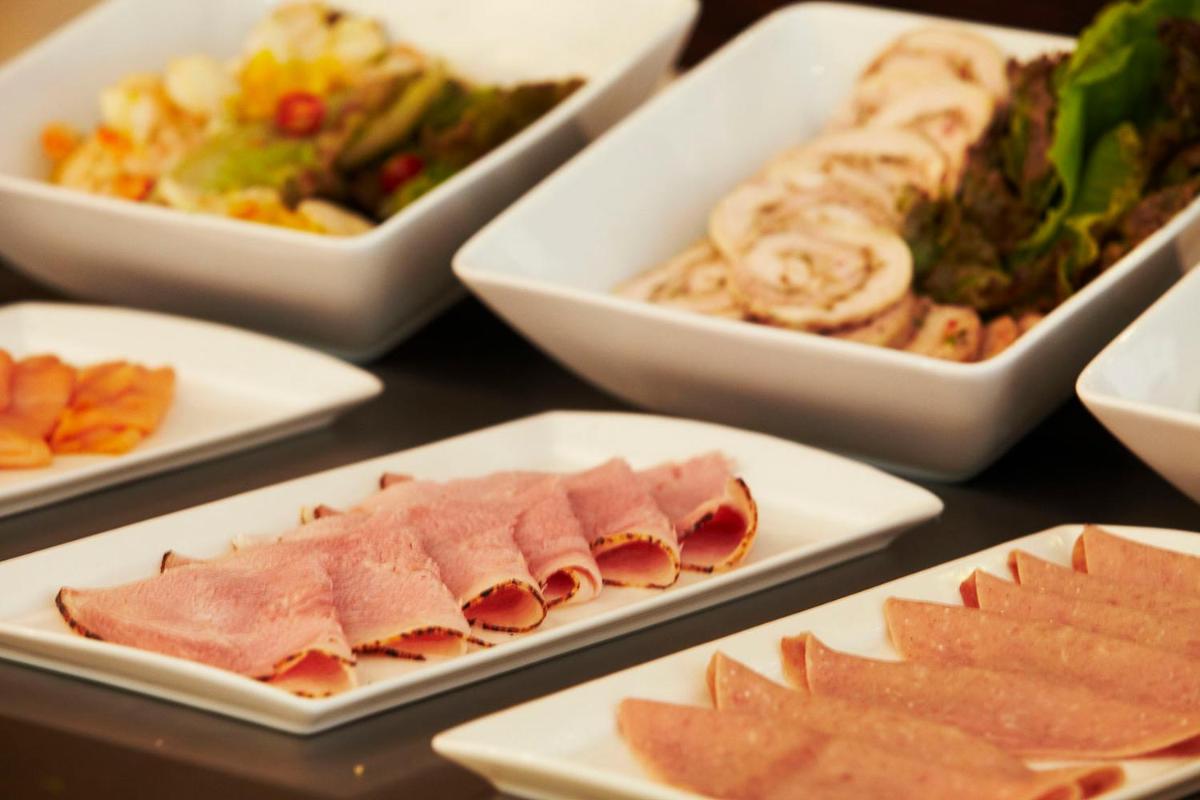 a table with several dishes of food on plates at Crowne Plaza Pune City Centre by IHG in Pune
