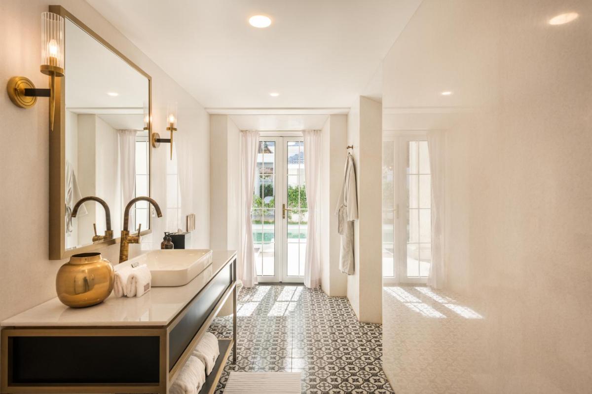 a bathroom with a sink and a large mirror at MansionHaus in Anjuna