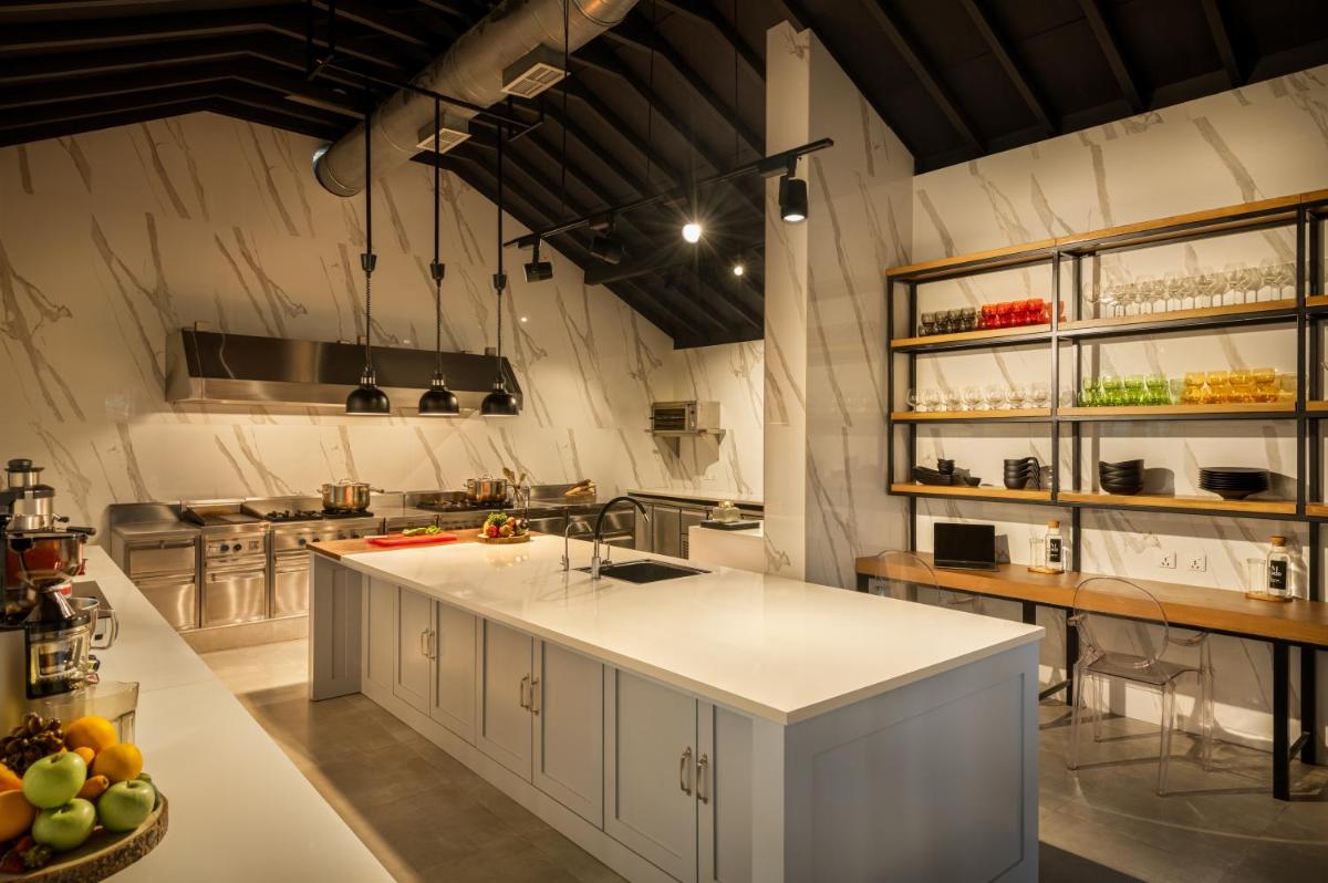 a large kitchen with a large white island in it at MansionHaus in Anjuna