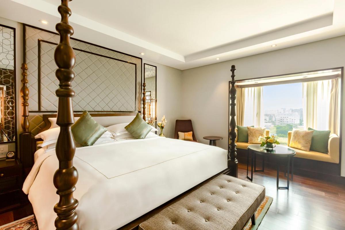 a bedroom with a large bed and a window at Taj Coromandel in Chennai