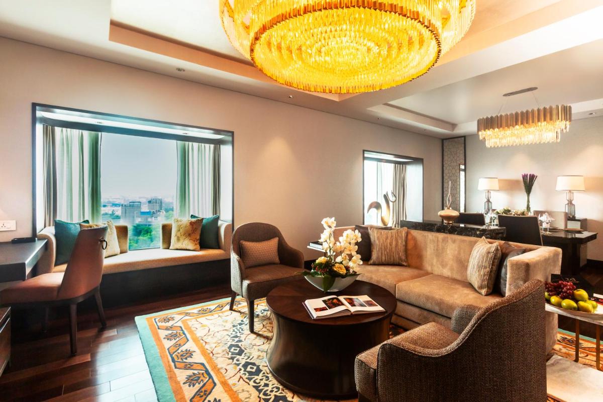 a living room with a couch and a table at Taj Coromandel in Chennai