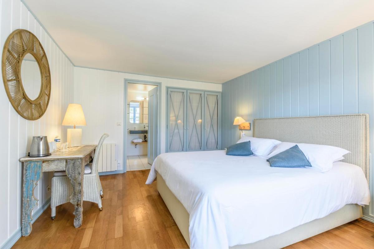 Un ou plusieurs lits dans un hébergement de l'établissement La Désirade - Hôtel, Spa & Restaurant