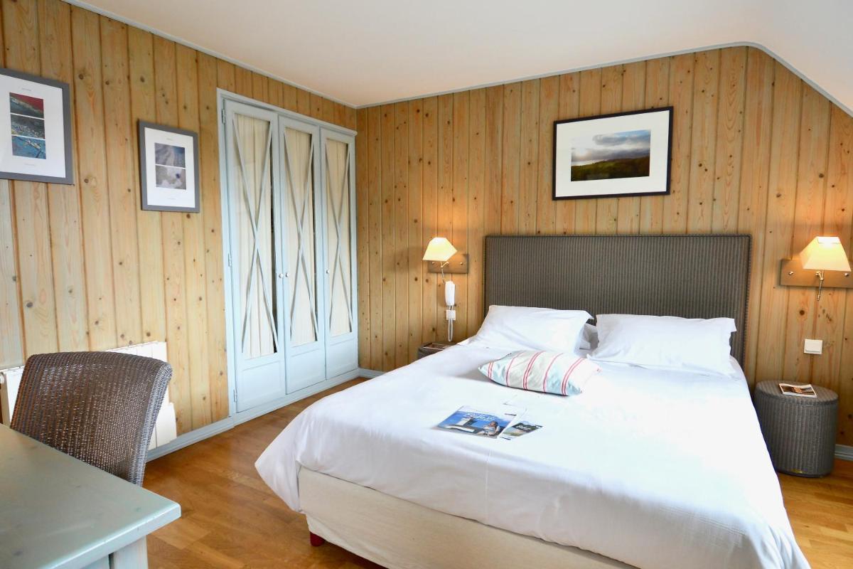 Un ou plusieurs lits dans un hébergement de l'établissement La Désirade - Hôtel, Spa & Restaurant