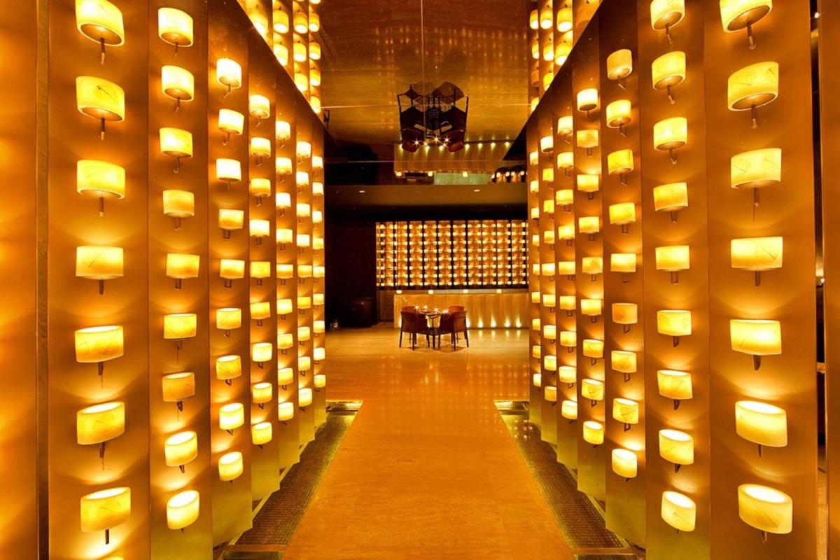 a room with lights on the wall with a table at Welcomhotel by ITC Hotels, Dwarka, New Delhi in New Delhi a room with lights on the wall with a table at Welcomhotel by ITC Hotels, Dwarka, New Delhi in New Delhi