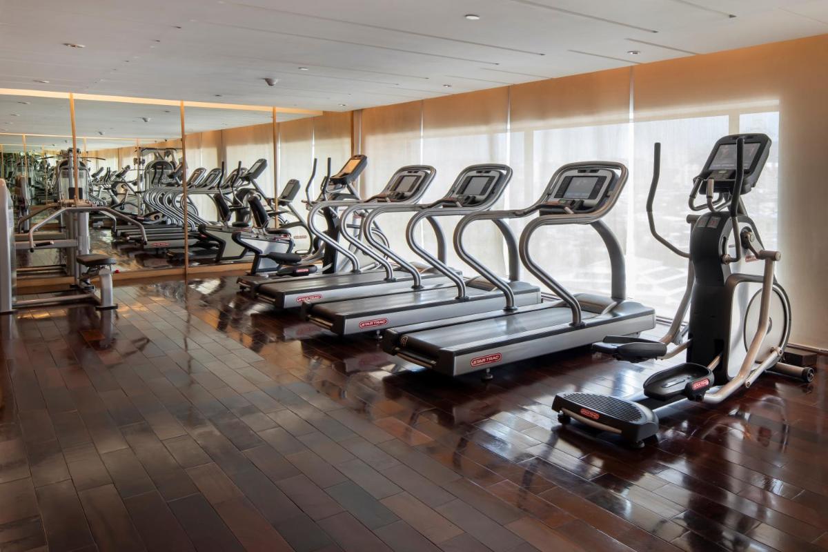a row of cardio machines in a gym at Holiday Inn Mumbai International Airport by IHG in Mumbai