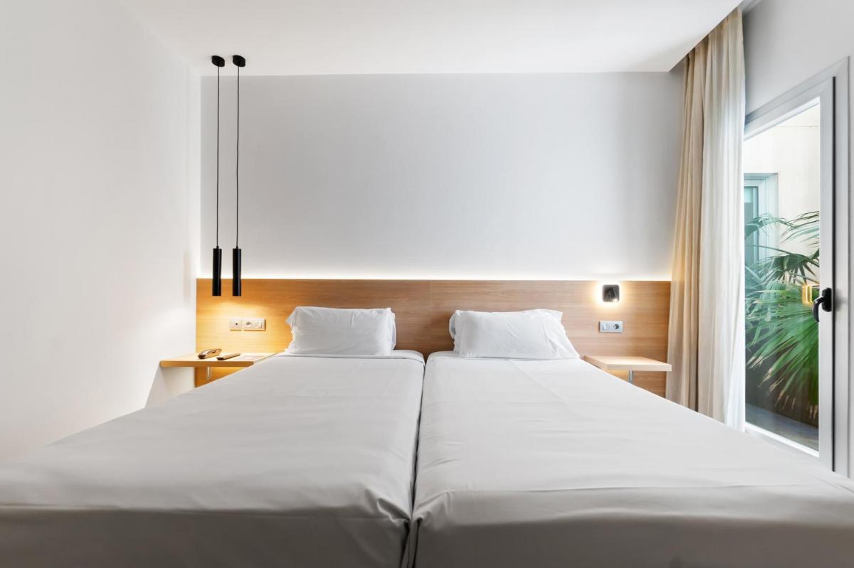 Cama o camas de una habitación en Hotel Areca