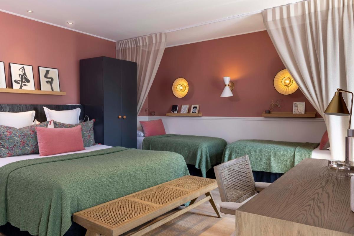 Un ou plusieurs lits dans un hébergement de l'établissement Le Petit Beaumarchais Hotel & Spa