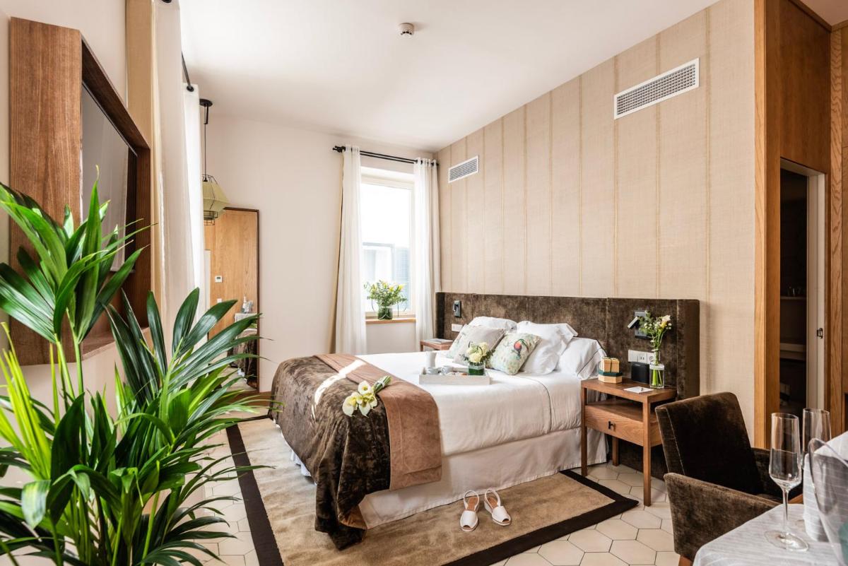 una habitación de hotel con una cama y una mesa en Boutique Hotel Sant Roc & Spa, en Mahón