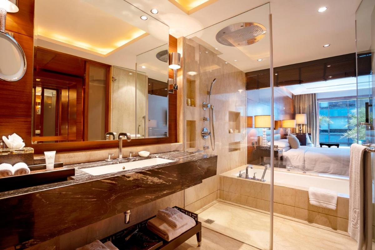a bathroom with a sink and a tub and a bed at The Leela Ambience Gurugram Hotel & Residences - The Luxury Urban Sanctuary in Gurgaon