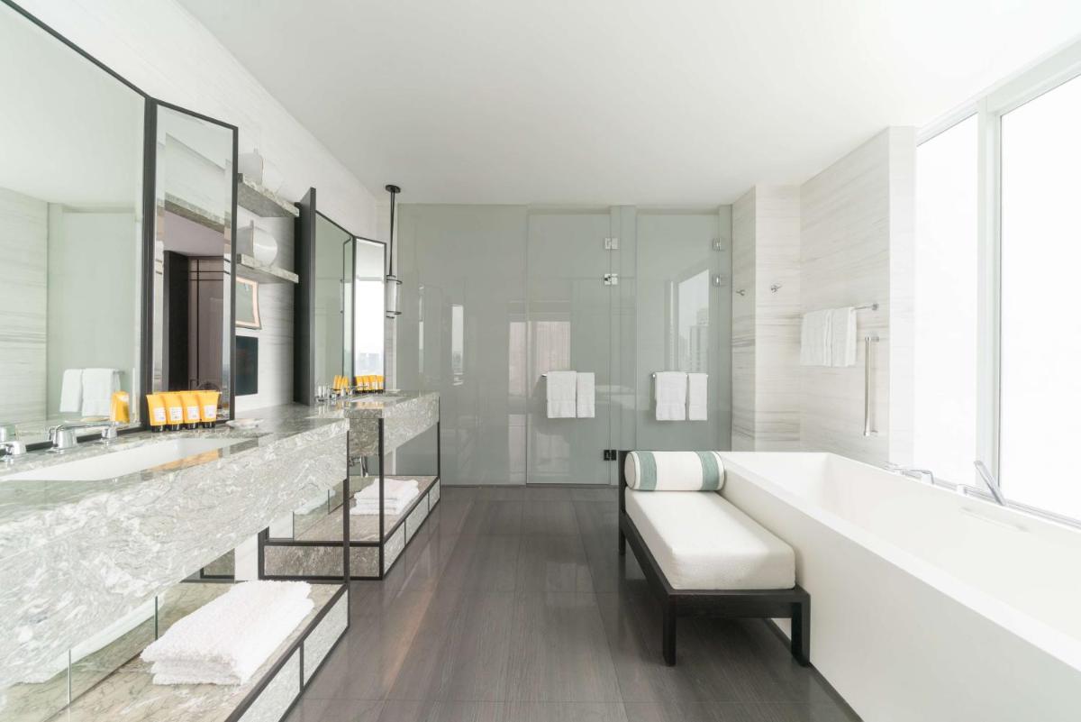 a white bathroom with two sinks and a tub at Shangri-La Singapore in Singapore
