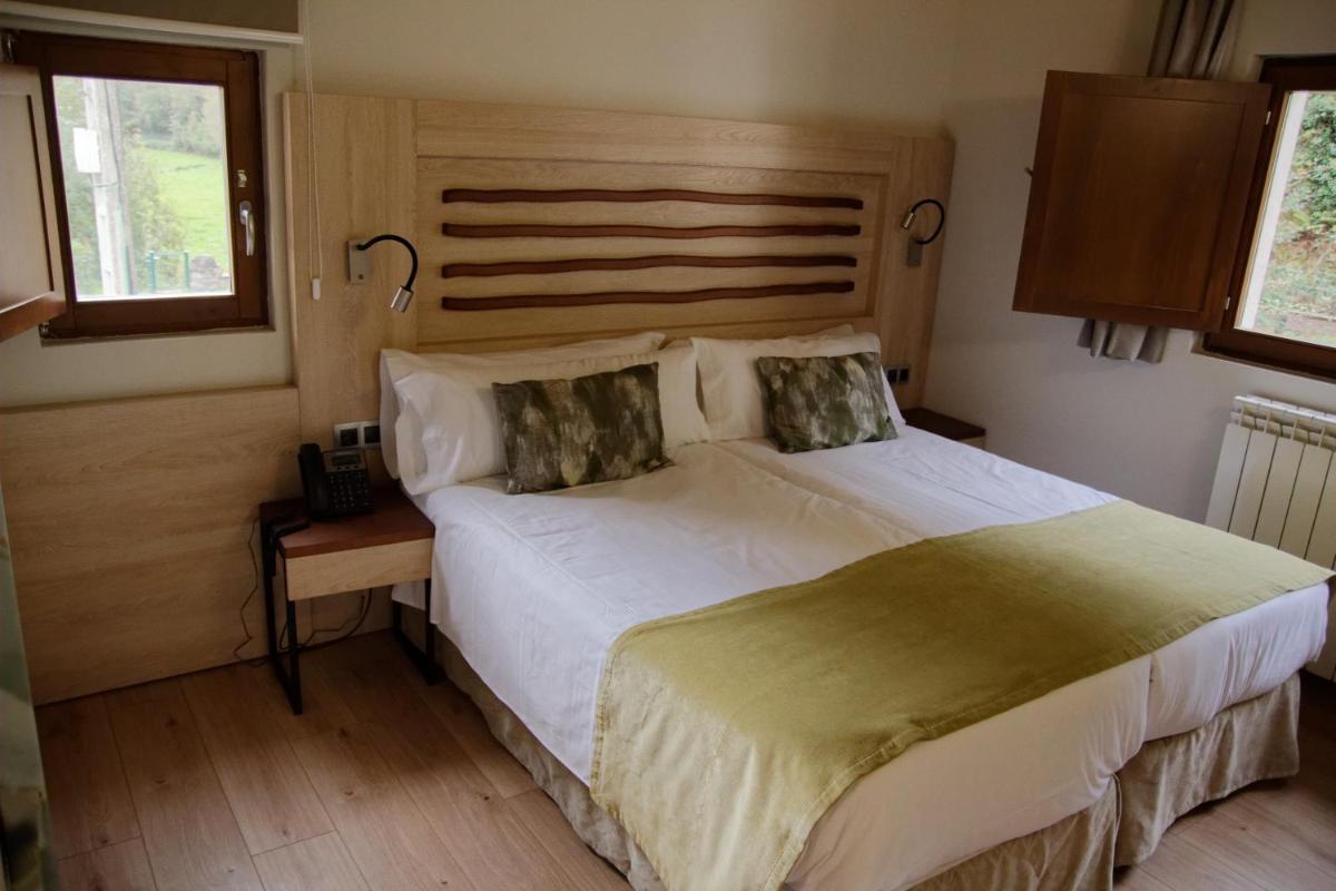 Cama o camas de una habitación en Hotel Rural Las Montañas de Pumar