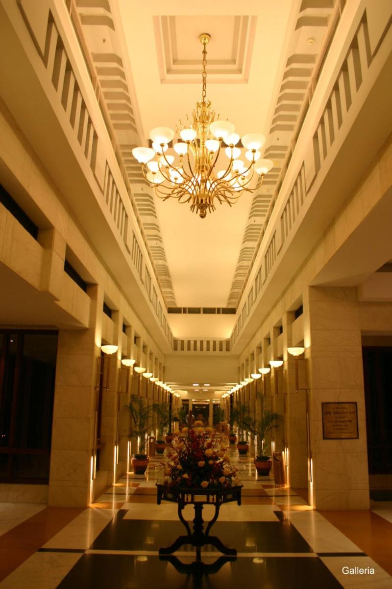 a large hallway with a chandelier in a building at Jaypee Palace Hotel in Agra