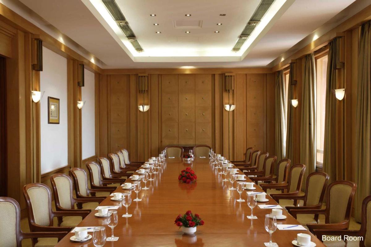a long room with a long table and chairs at Jaypee Palace Hotel in Agra