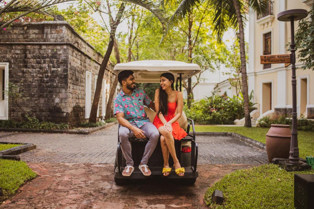 a man and a woman sitting on a golf cart at Grand Hyatt Goa in Panaji a man and a woman sitting on a golf cart at Grand Hyatt Goa in Panaji