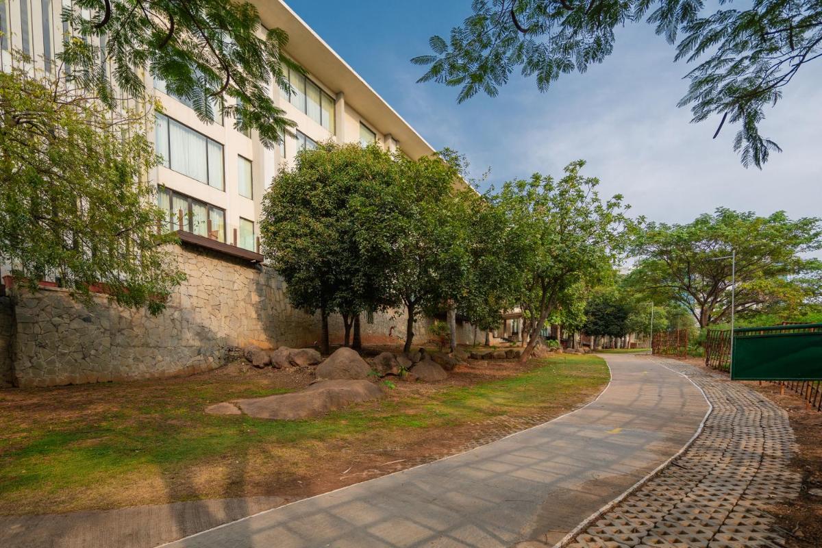 a road in front of a building at Hyatt Hyderabad Gachibowli in Hyderabad