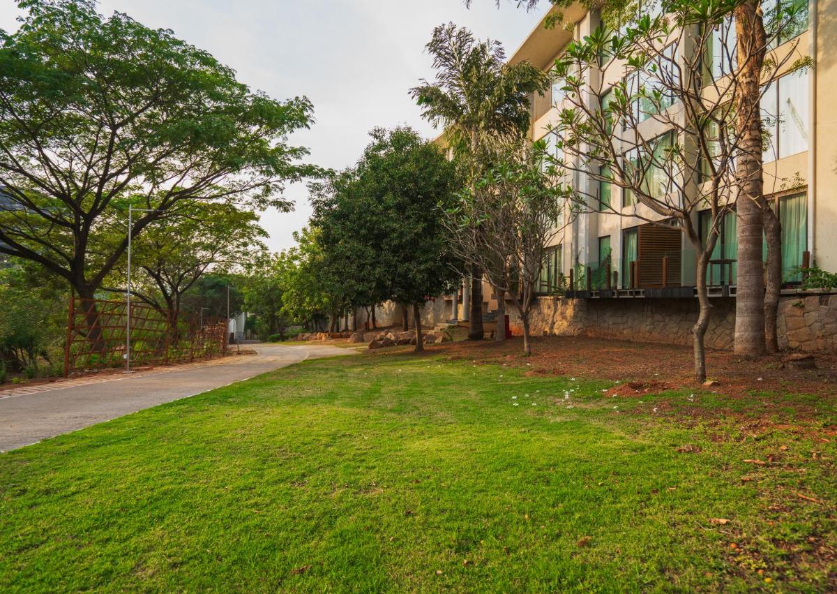 an empty street in front of a building at Hyatt Hyderabad Gachibowli in Hyderabad