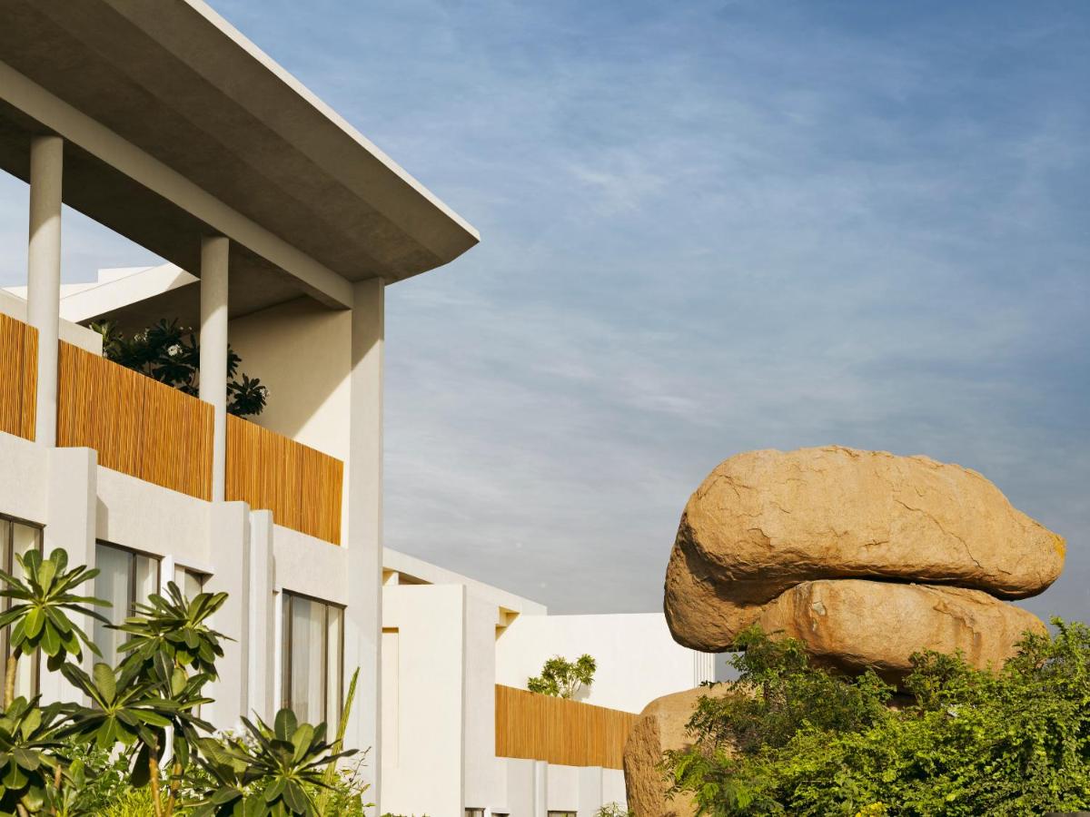 a building with a large rock in front of it at Hyatt Hyderabad Gachibowli in Hyderabad
