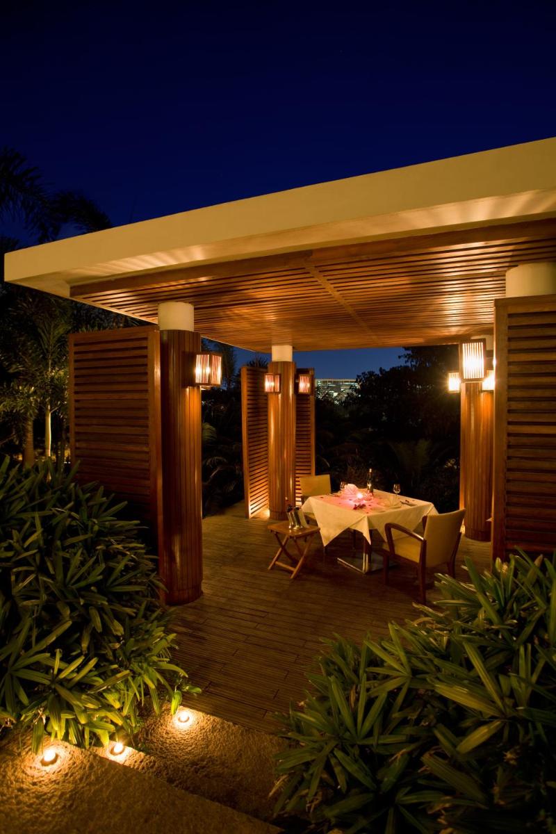 a patio with a table and lights at night at Hyatt Hyderabad Gachibowli in Hyderabad