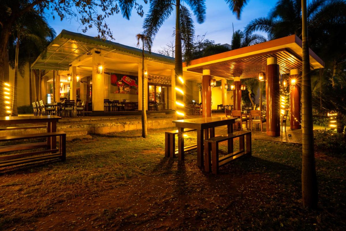 a restaurant with a table in front of it at night at Hyatt Hyderabad Gachibowli in Hyderabad