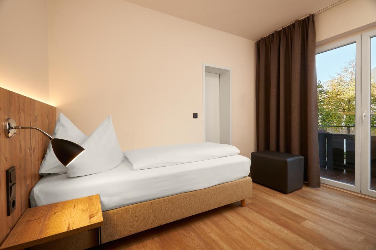 Ein Bett oder Betten in einem Zimmer der Unterkunft HYPERION Hotel Garmisch - Partenkirchen