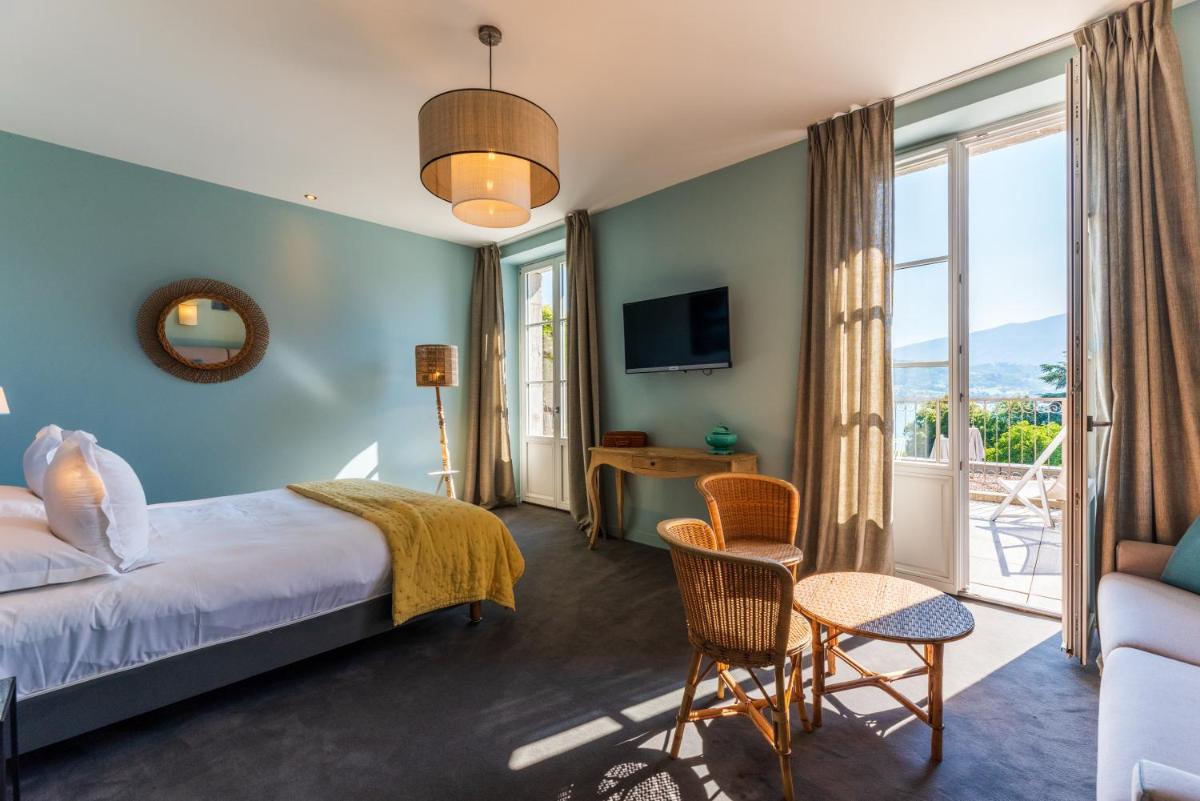 Un ou plusieurs lits dans un hébergement de l'établissement Hôtel Beau Site Talloires B SPA