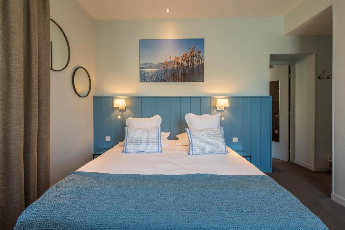 Un ou plusieurs lits dans un hébergement de l'établissement Hôtel Beau Site Talloires B SPA