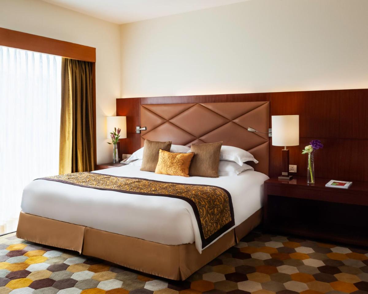 a bedroom with a large bed in a hotel room at Taj Chandigarh in Chandīgarh +29 photos