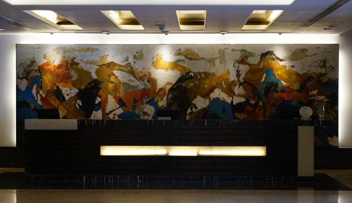 a large painting on a wall in a building at Taj Chandigarh in Chandīgarh