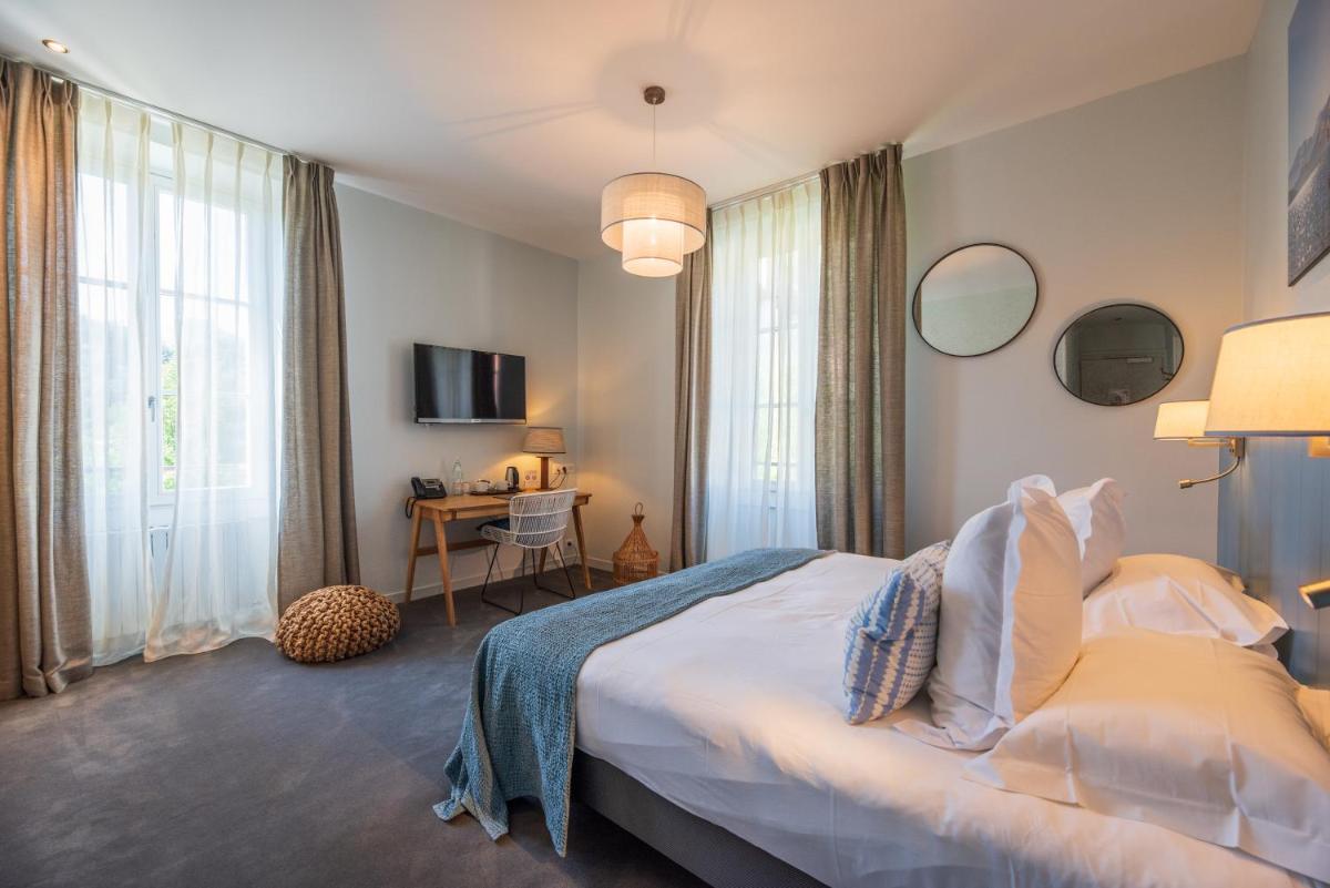 Un ou plusieurs lits dans un hébergement de l'établissement Hôtel Beau Site Talloires B SPA