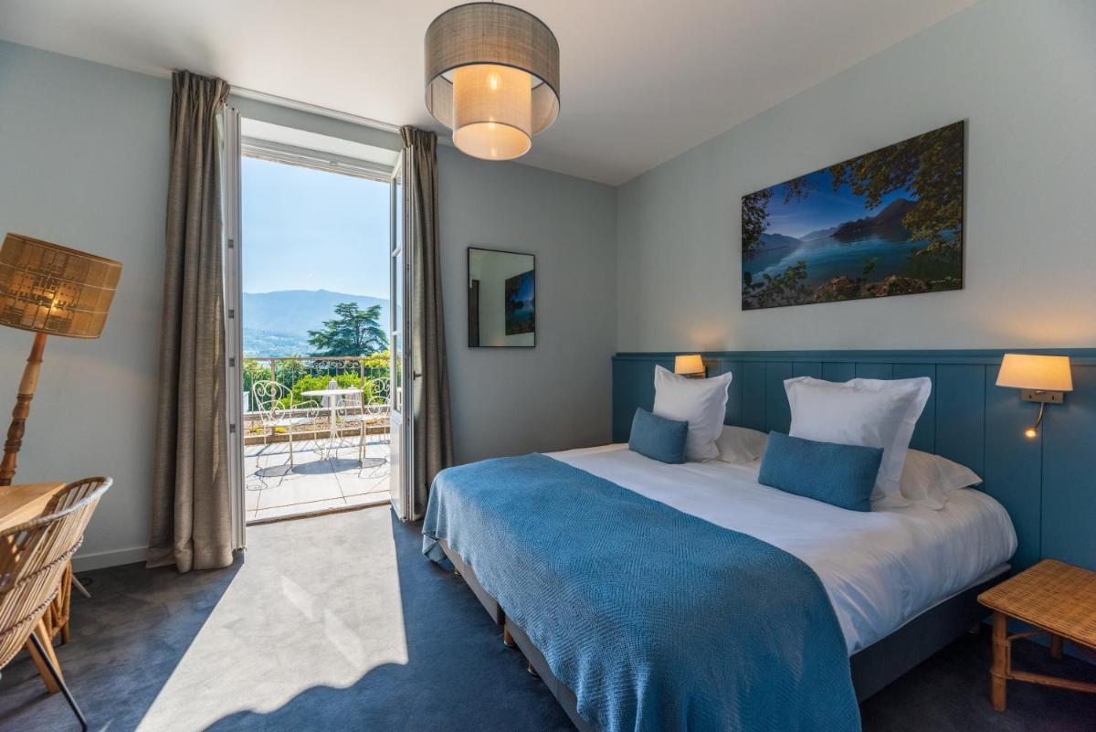 Un ou plusieurs lits dans un hébergement de l'établissement Hôtel Beau Site Talloires B SPA