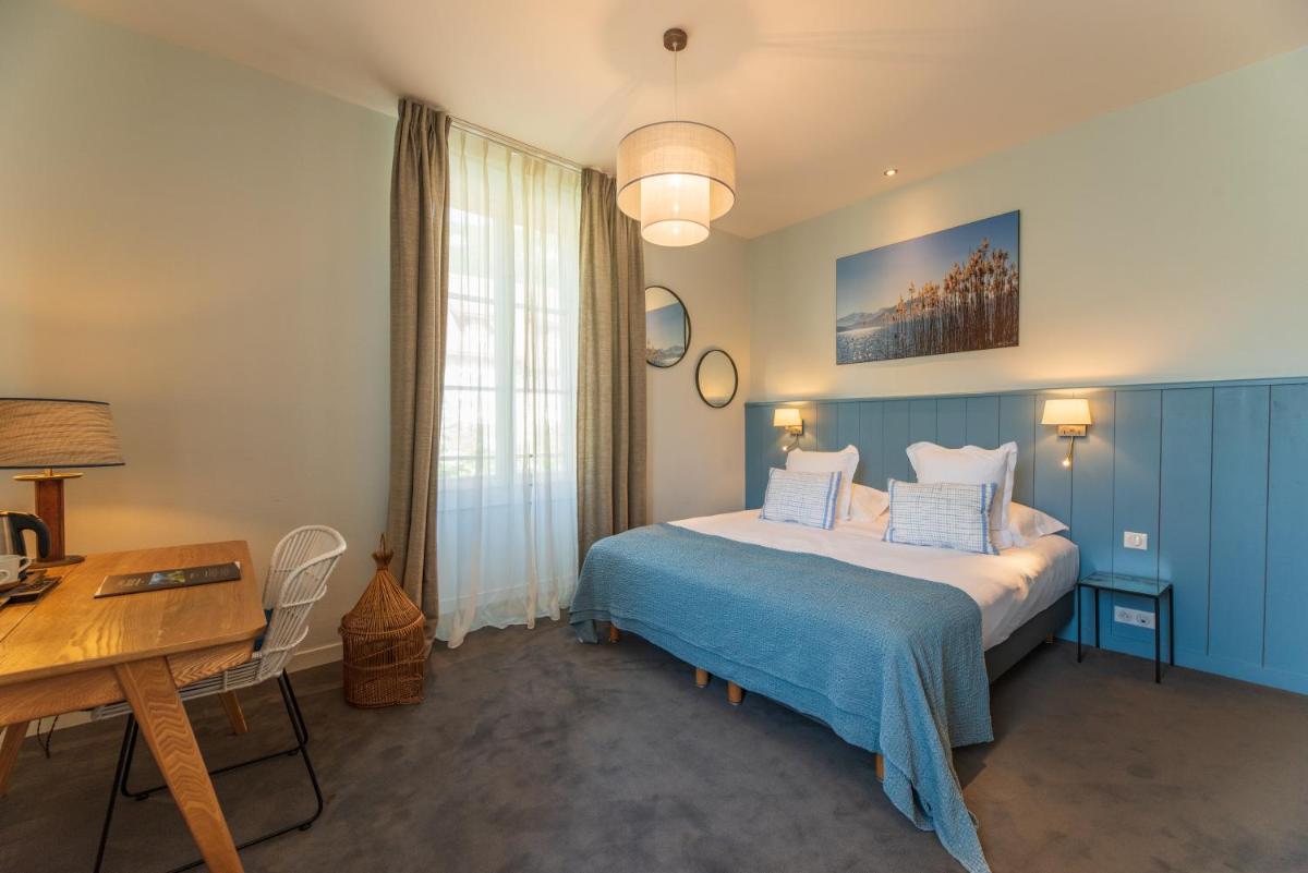 Un ou plusieurs lits dans un hébergement de l'établissement Hôtel Beau Site Talloires B SPA