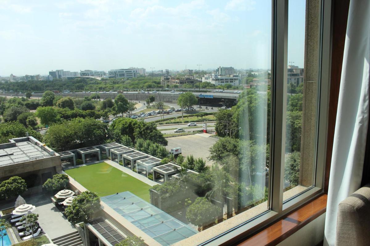 a view of a park from a window at Crowne Plaza Today Gurugram by IHG in Gurgaon