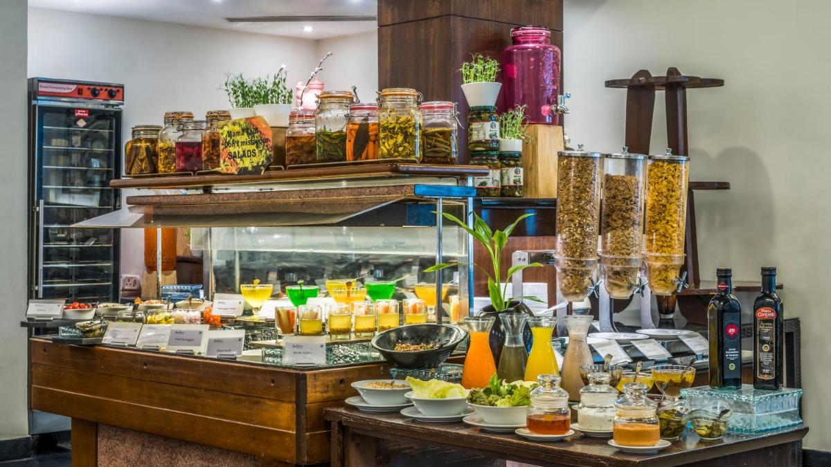 a buffet with a lot of food on a table at Radisson Goa Candolim in Candolim