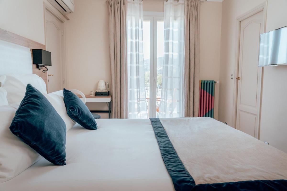 Un ou plusieurs lits dans un hébergement de l'établissement Ermitage de l'Oasis & Spa - Cannes Mandelieu