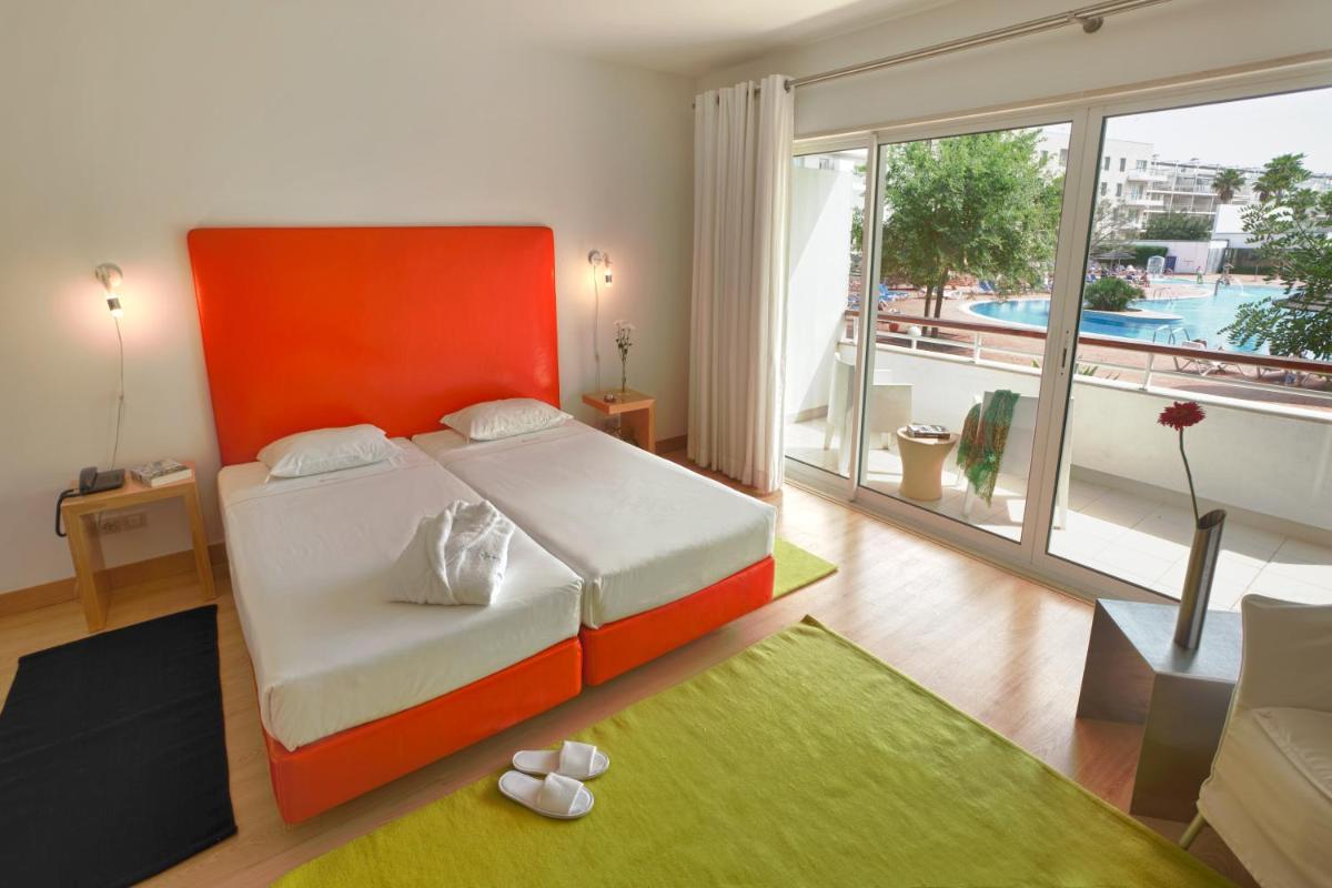 Uma cama ou camas num quarto em Marina Club Lagos Resort