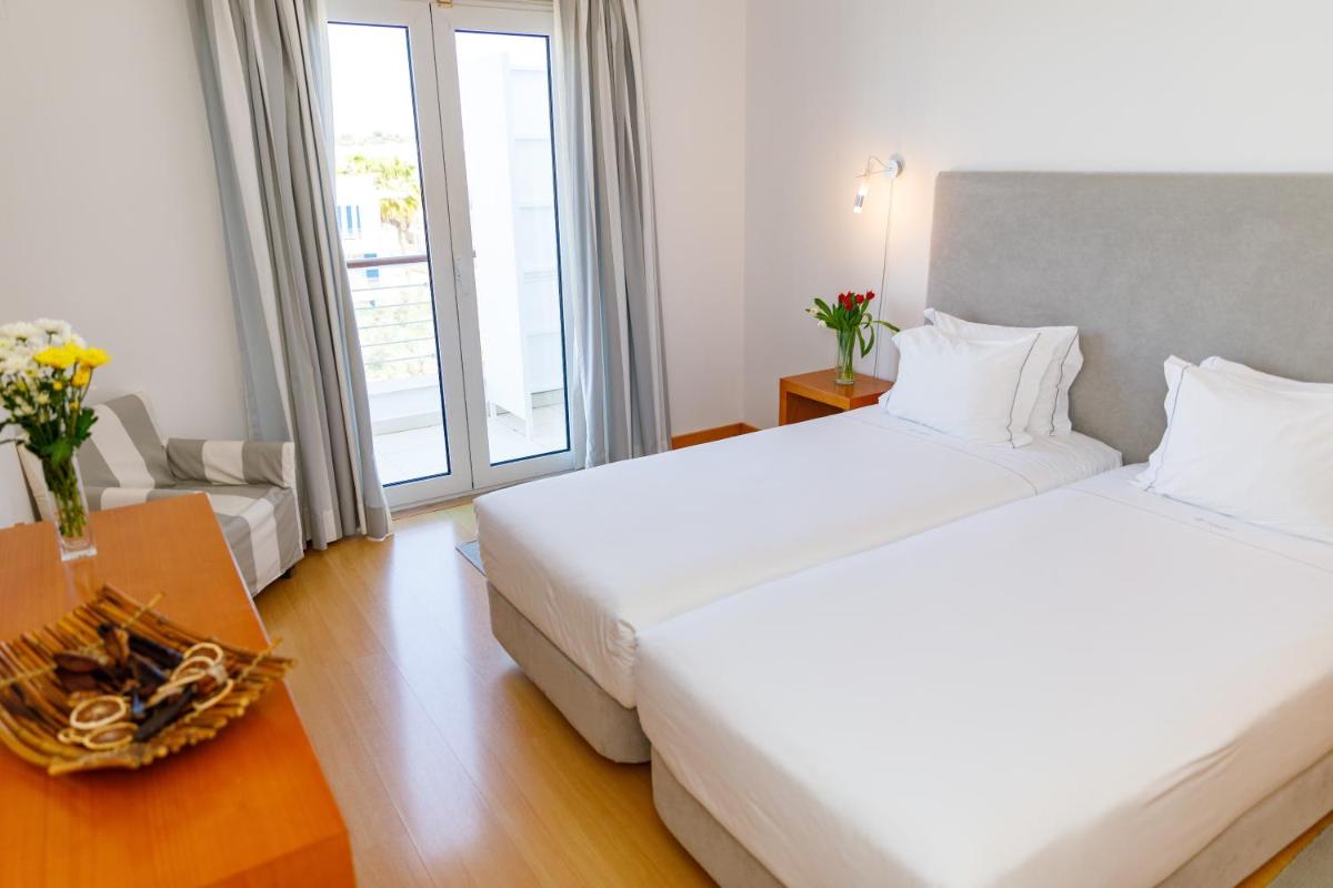 Uma cama ou camas num quarto em Marina Club Lagos Resort