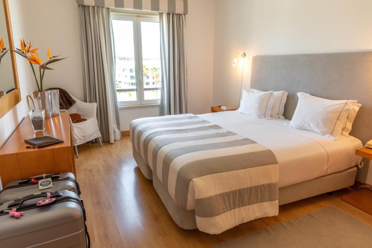 Uma cama ou camas num quarto em Marina Club Lagos Resort