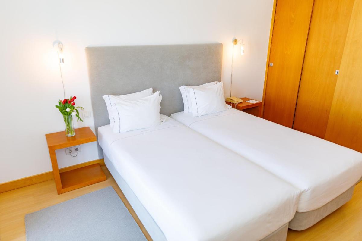 Uma cama ou camas num quarto em Marina Club Lagos Resort