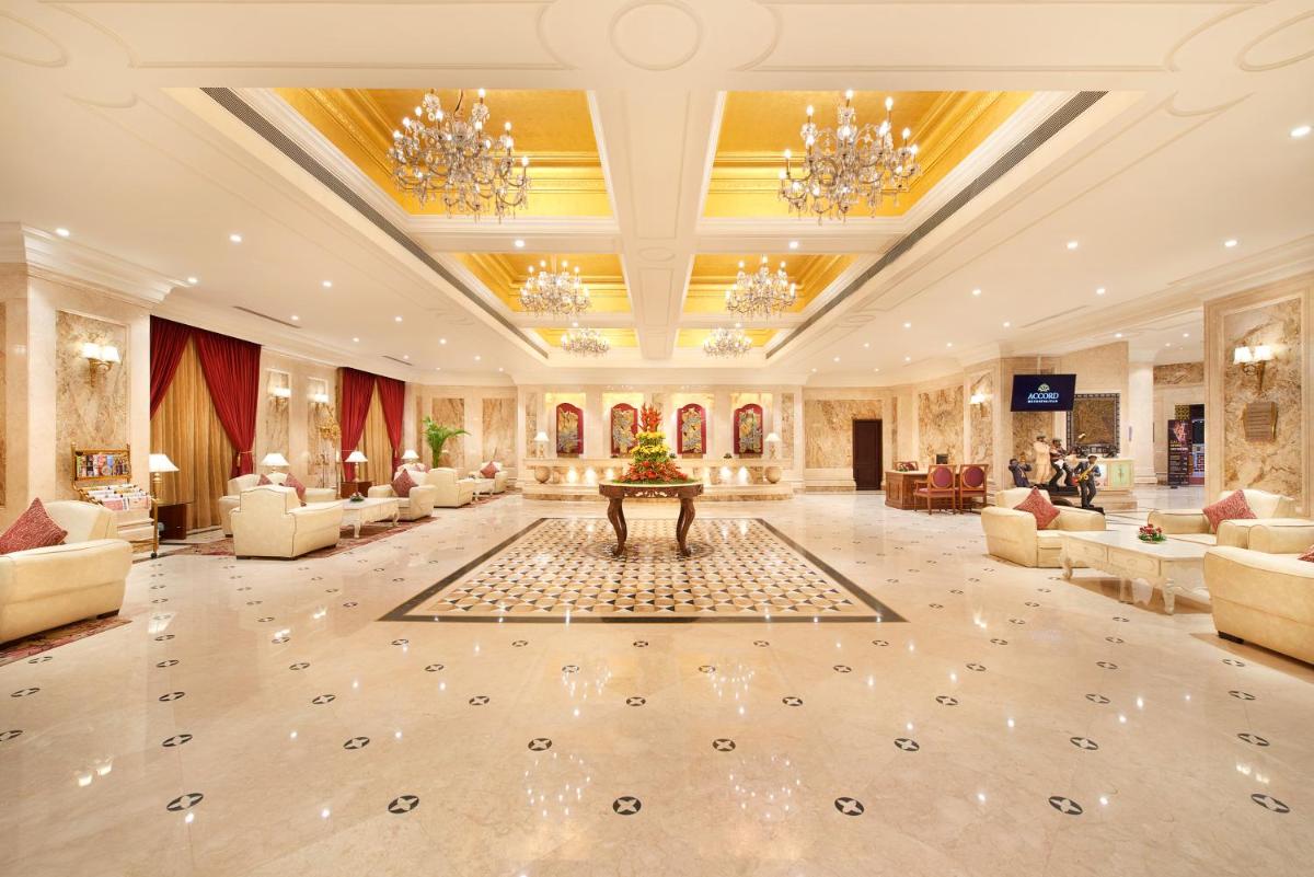 a large lobby with couches and a table in the middle at The Accord Metropolitan in Chennai