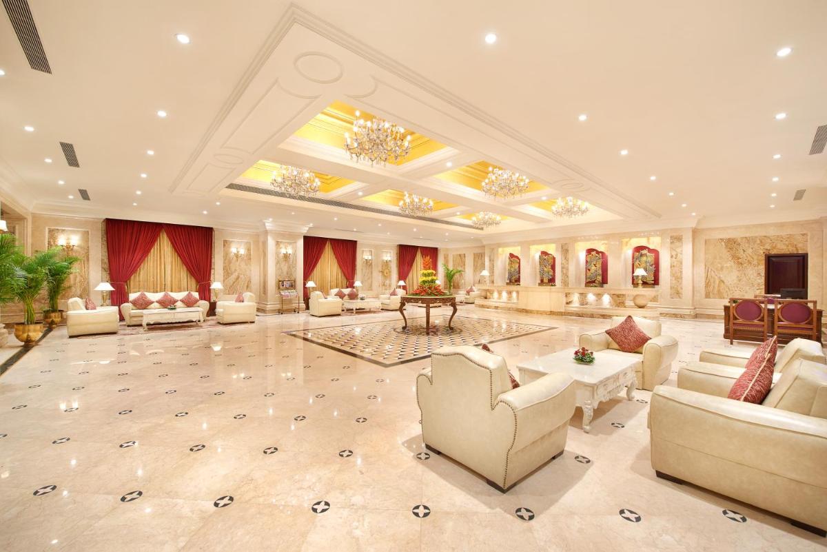 a large living room with couches and a chandelier at The Accord Metropolitan in Chennai
