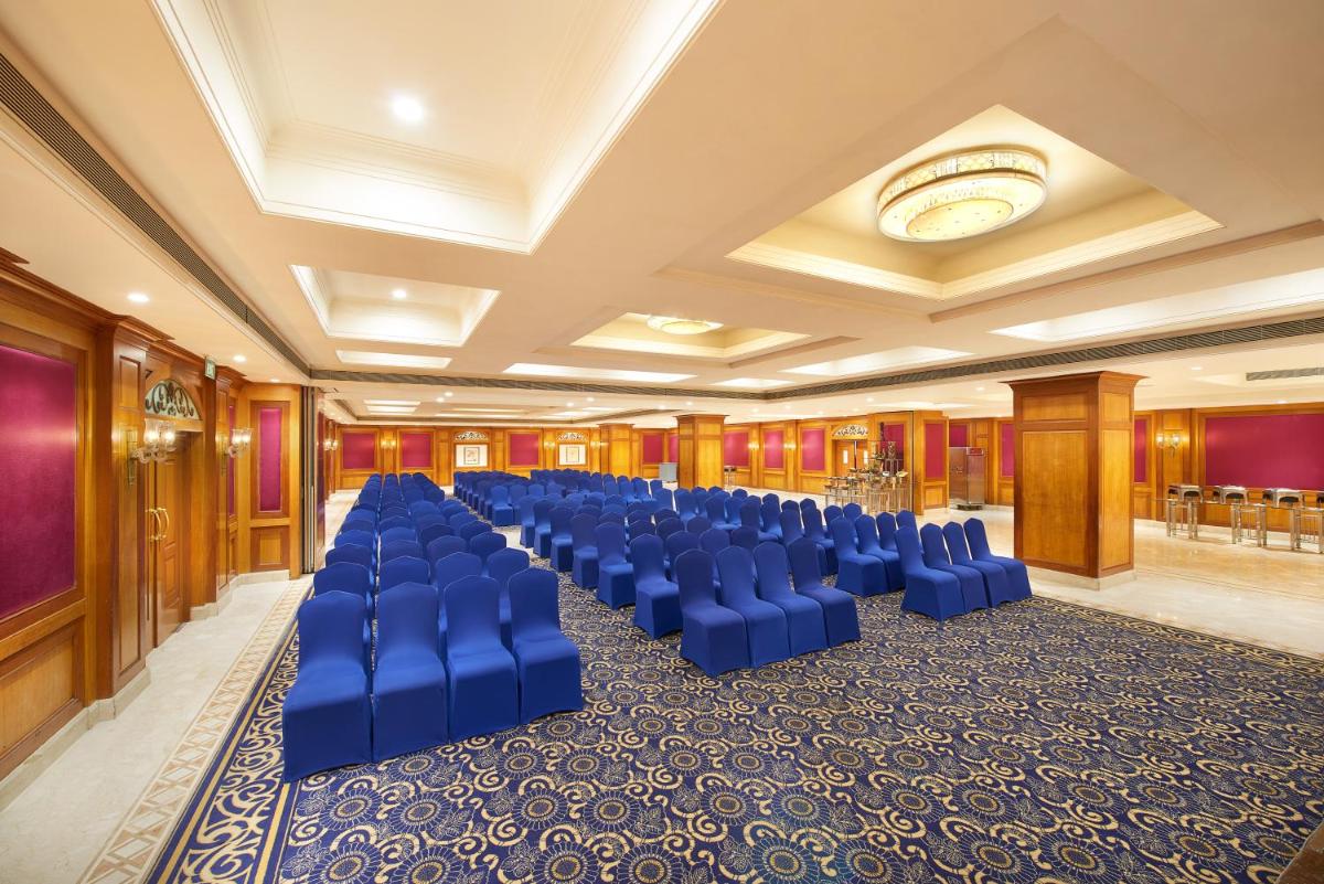 a banquet hall with blue chairs in a room at The Accord Metropolitan in Chennai