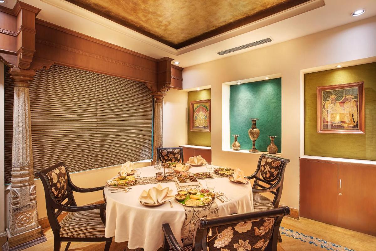 a dining room with a table and chairs at The Accord Metropolitan in Chennai